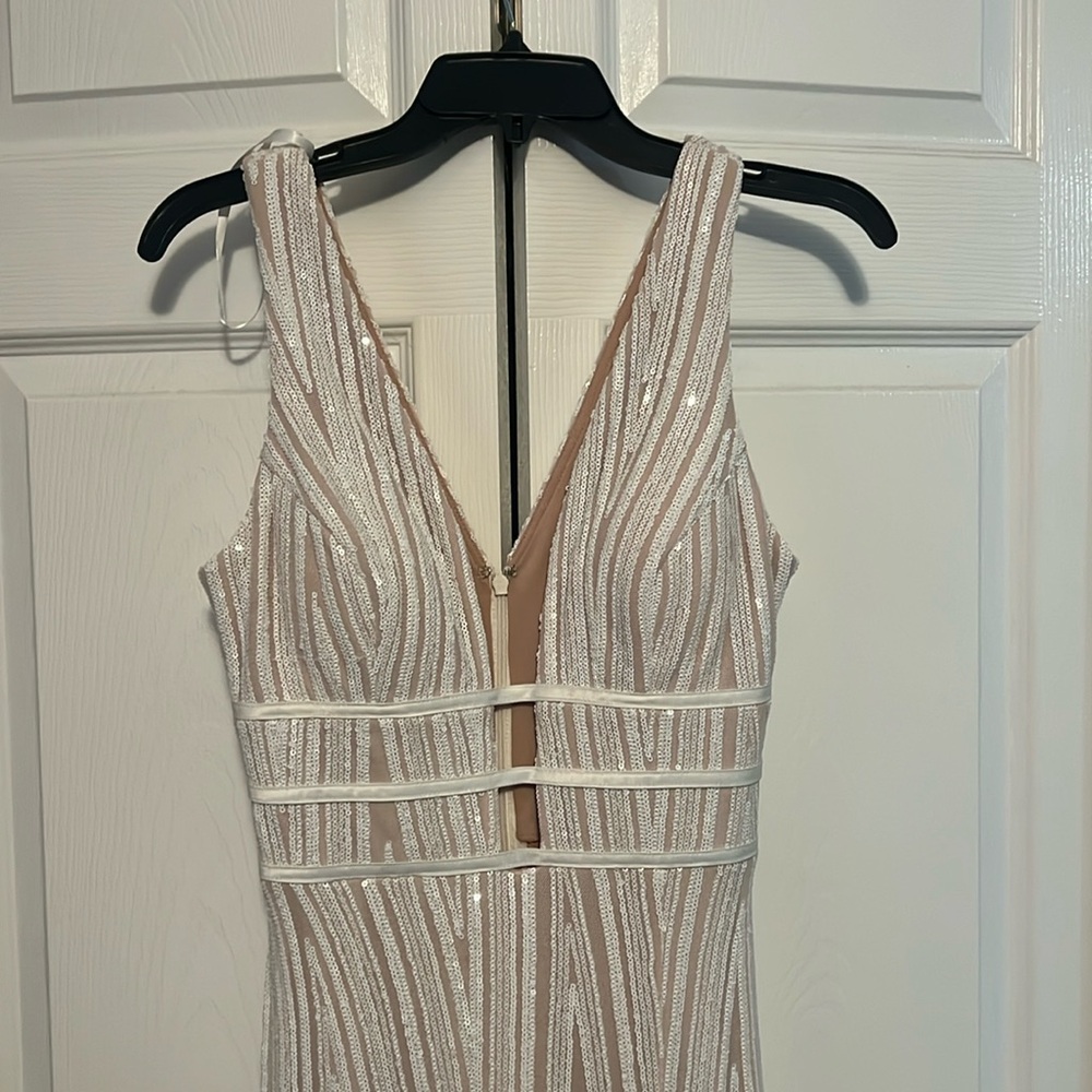 Brand new never worn. Showy in front. Bottom slit. Cream, white sequins dress.